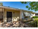 Welcoming home entrance with an ornate security door, brick-paved porch, and awnings for added charm at 1320 W Mariposa St, Phoenix, AZ 85013