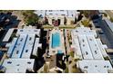 Aerial view of the apartment complex and community pool, showcasing a tranquil and well-maintained living environment at 1340 N Recker Rd # 219, Mesa, AZ 85205