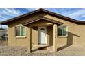 Front entrance features neutral brickwork and a covered porch, inviting entrance and curb appeal at 14024 W Noble Cir, Casa Grande, AZ 85122