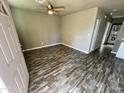 Open-concept living room featuring contemporary flooring and neutral tones, ideal for flexible living spaces at 14024 W Noble Cir, Casa Grande, AZ 85122