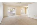 Bright living room with neutral carpeting and sliding glass doors leading to the backyard patio at 14215 N Boswell Blvd, Sun City, AZ 85351