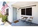 Covered porch with a charming outdoor seating area, front door, and a view of the front yard at 14433 N 37Th St, Phoenix, AZ 85032