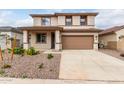 Charming two-story home with a two car garage, landscaped front yard, and neutral color palette at 16954 W Molly Ln, Surprise, AZ 85387