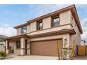 Charming two-story home with a two car garage, landscaped front yard, and neutral color palette at 16954 W Molly Ln, Surprise, AZ 85387