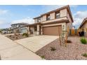 Charming two-story home with a two car garage, landscaped front yard, and neutral color palette at 16954 W Molly Ln, Surprise, AZ 85387