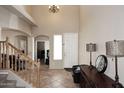 Bright entryway featuring tile flooring, staircase, soaring ceilings, and modern chandelier at 1765 N Agave St, Casa Grande, AZ 85122