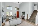 Bright living room with a fireplace, large windows, and tile flooring at 2015 S 80Th Ln, Phoenix, AZ 85043