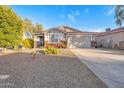 Inviting single-story residence with a two-car garage and drought-resistant landscaping, enhancing its curb appeal at 28249 N Shundeen Cir, San Tan Valley, AZ 85143