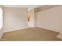 Spacious living room with neutral carpet and light-colored walls provides a versatile space at 3151 W Donald Dr, Phoenix, AZ 85027