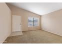 Bright living room with neutral carpet, window and light-colored walls at 3151 W Donald Dr, Phoenix, AZ 85027