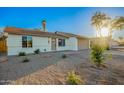 Attractive exterior showcasing desert landscaping, a neutral color scheme, and attached two-car garage at 331 W Stanford Ave, Gilbert, AZ 85233