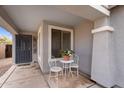 Inviting front porch with decorative chairs and table, perfect for enjoying the outdoors at 34717 N Picket Post Dr, San Tan Valley, AZ 85144