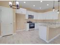 Bright kitchen featuring white cabinets, granite counters, and stainless steel appliances at 4130 N Del Monte Dr, Eloy, AZ 85131