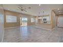 Open-concept living room and kitchen with tile floors and sliding glass doors at 4130 N Del Monte Dr, Eloy, AZ 85131