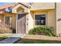 Close up of front door featuring security screen and desert landscaping at 455 S Mesa Dr # 126, Mesa, AZ 85210