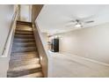 Open-concept living space with a staircase leading up and kitchen view at 455 S Mesa Dr # 126, Mesa, AZ 85210