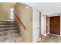 Hallway with carpeted stairs and wood railing, leading up to a door on the upper level at 6159 E Indian School Rd # 110, Scottsdale, AZ 85251