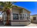 Attractive home featuring a welcoming porch, neutral siding, decorative windows and mature landscaping at 632 Aero Rd, Mesa, AZ 85205