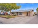 Spacious home with a covered carport and a large driveway at 6405 N 46Th Dr, Glendale, AZ 85301