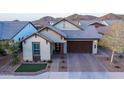 Attractive single-Gathering home with a brick driveway, attached two-car garage, and mountain views at 6926 W Spur Dr, Peoria, AZ 85383