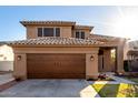 Beautiful two-story home featuring an attached two car garage and tiled roof at 7371 W Louise Dr, Glendale, AZ 85310