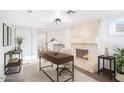 Cozy office space with a stone fireplace, modern desk and chair, and ensuite bathroom at 7819 N 17Th Ave, Phoenix, AZ 85021