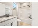 Modern bathroom boasts granite counters, bright white cabinetry, and a shower-tub combo at 7854 W Mockingbird Way, Florence, AZ 85132