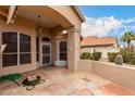 Covered patio with stone flooring, a view of the backyard, stucco walls, and outdoor access, perfect for outdoor relaxation at 7866 W Taro Ln, Glendale, AZ 85308