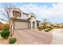 Beautiful two-story home with well-maintained landscaping, a two-car garage, and a brick driveway at 8740 W San Miguel Ave, Glendale, AZ 85305