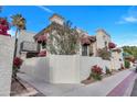 Exterior shows a building with red awnings, landscaping, privacy wall, and two-story design at 8840 S 51St St # 2, Phoenix, AZ 85044