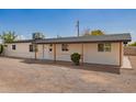 Inviting single-story home with covered entryway and minimalist desert landscaping at 9127 E Broadway Rd, Mesa, AZ 85208