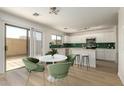 Bright kitchen featuring white cabinets, stainless steel appliances and a sliding glass door at 9643 N 81St Dr, Peoria, AZ 85345