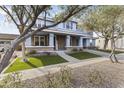 Charming two-story home boasts a brick-accented facade, fresh landscaping, and a welcoming front porch at 12956 N 152Nd Ave, Surprise, AZ 85379