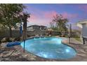 Sparkling private pool with water features and manicured landscaping in a serene backyard setting at 12956 N 152Nd Ave, Surprise, AZ 85379