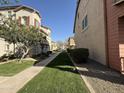 A well-maintained walkway and lawn highlight the community's curb appeal at 1304 S Owl Dr, Gilbert, AZ 85296