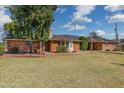 Charming single-story brick house with well-kept lawn, solar panels, and beautiful landscaping at 1610 E Mclellan Rd, Mesa, AZ 85203