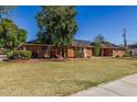 Beautiful red brick home with a well-manicured lawn and decorative brick accents, creating a warm curb appeal at 1610 E Mclellan Rd, Mesa, AZ 85203