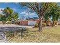 Side view of a brick home with a two-car garage and extended driveway at 1610 E Mclellan Rd, Mesa, AZ 85203
