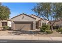 Attractive single-story home with a two-car garage and desert-friendly landscaping at 16232 W Montoya Dr, Surprise, AZ 85374