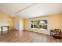 Bright living room with wood floors, large window, and cozy seating area at 18256 N 75Th Ave, Glendale, AZ 85308