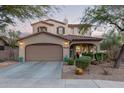 Charming two-story home featuring a well-manicured front yard and a spacious two-car garage at 18413 W Paseo Way, Goodyear, AZ 85338