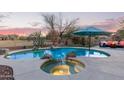 Gorgeous pool and spa with lush desert landscaping and a charming outdoor seating area at 18413 W Paseo Way, Goodyear, AZ 85338
