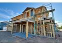 Image of a home under construction, featuring wood framing, scaffolding, and a clear blue sky above at 1905 W Lariat Ln, Phoenix, AZ 85085