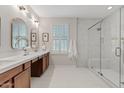 Bright bathroom with dual vanity, sleek fixtures, and a glass-enclosed shower with marble-style tile at 2670 E Parkview Dr, Gilbert, AZ 85295