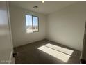 A bright bedroom with carpet, a large window, and ample sunlight at 32723 N Newby Dr, San Tan Valley, AZ 85140