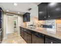 Modern kitchen features dark cabinetry, granite countertops, and stainless steel appliances at 3640 W Redfield Rd, Phoenix, AZ 85053