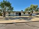 Attractive single-story home featuring desert landscaping and a covered front entry at 3807 E Altadena Ave, Phoenix, AZ 85028