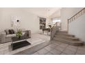 Bright living room featuring a sofa, dining area, staircase, and modern decor at 4531 W Flint St, Chandler, AZ 85226