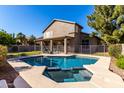 Backyard swimming pool and spa surrounded by pavers, enclosed with a metal fence, and lush landscaping at 4531 W Flint St, Chandler, AZ 85226