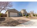 Well-maintained house featuring a spacious garage and brick-paved driveway, surrounded by desert landscaping at 4884 S Hemet St, Gilbert, AZ 85298